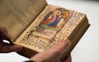 Fr. Columba Stewart held a 14th century book of hours from France at St. John's University in Collegeville, Minn., on Friday, December 1, 2017. Stewar