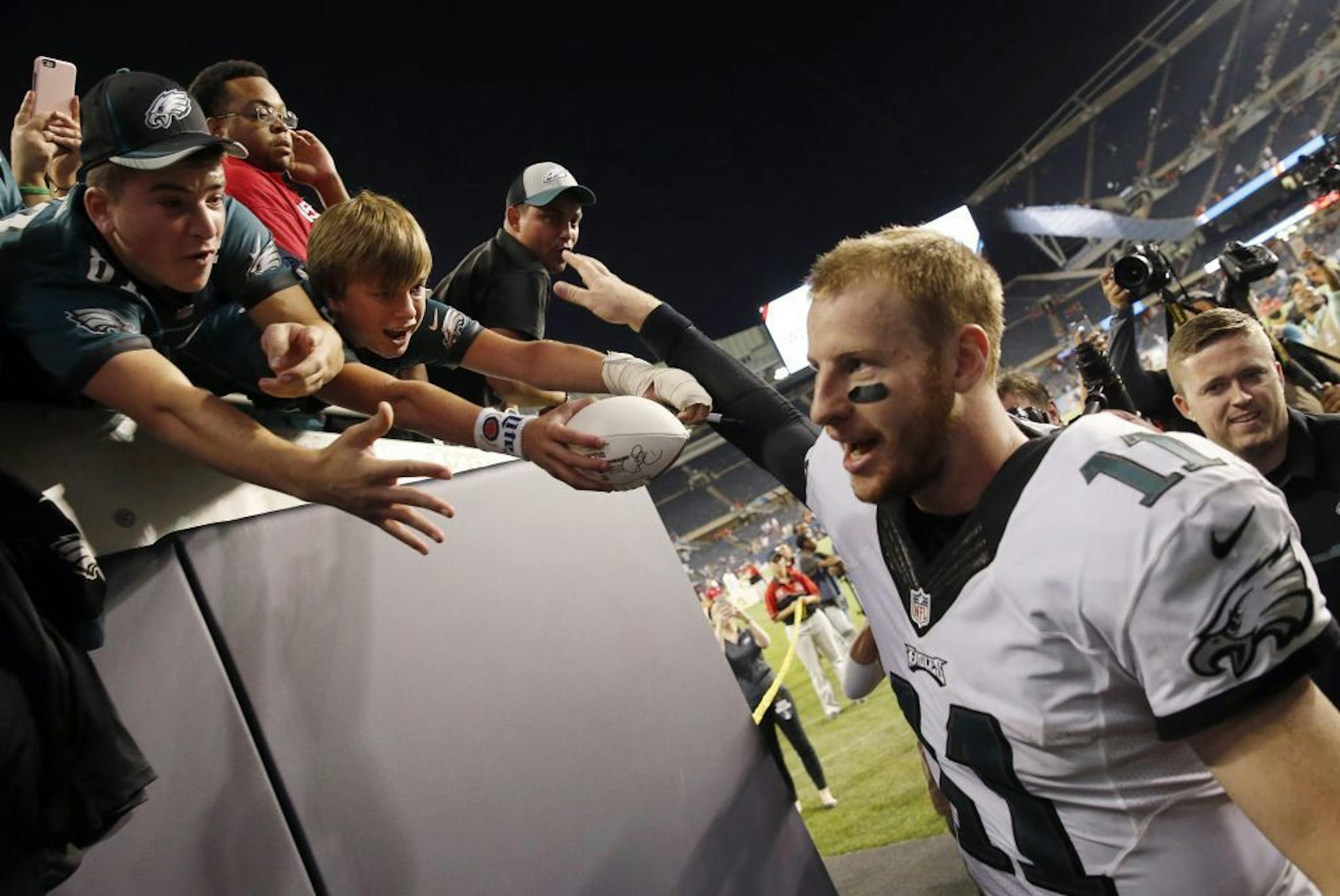 Philadelphia Eagles quarterback Carson Wentz (11) celebrates with fans after an NFL football game against the Chicago Bears, Monday, Sept. 19, 2016, in Chicago. The Eagles won 29-14.