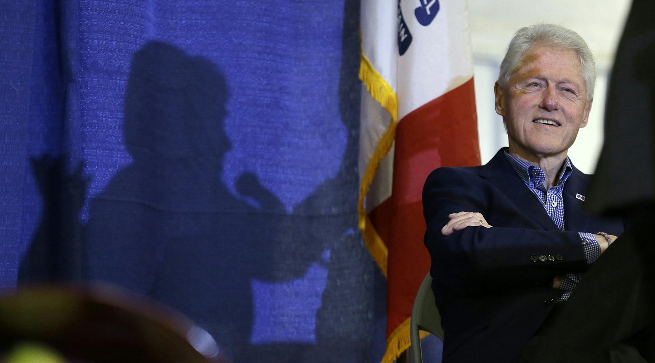 FILE - In this Nov. 15, 2015 file photo, former President Bill Clinton listens as his wife, Democratic presidential candidate Hillary Clinton speaks in Ames, Iowa. Bill Clinton promised voters in 1992 that theyíd be getting ìtwo for the price of oneî if they elected him to the White House, a presidential duo of the young Arkansas governor and his Yale Law-educated wife. Near a quarter century later, the duo is back, but not quite the same. (AP Photo/Charlie Neibergall, File) ORG X