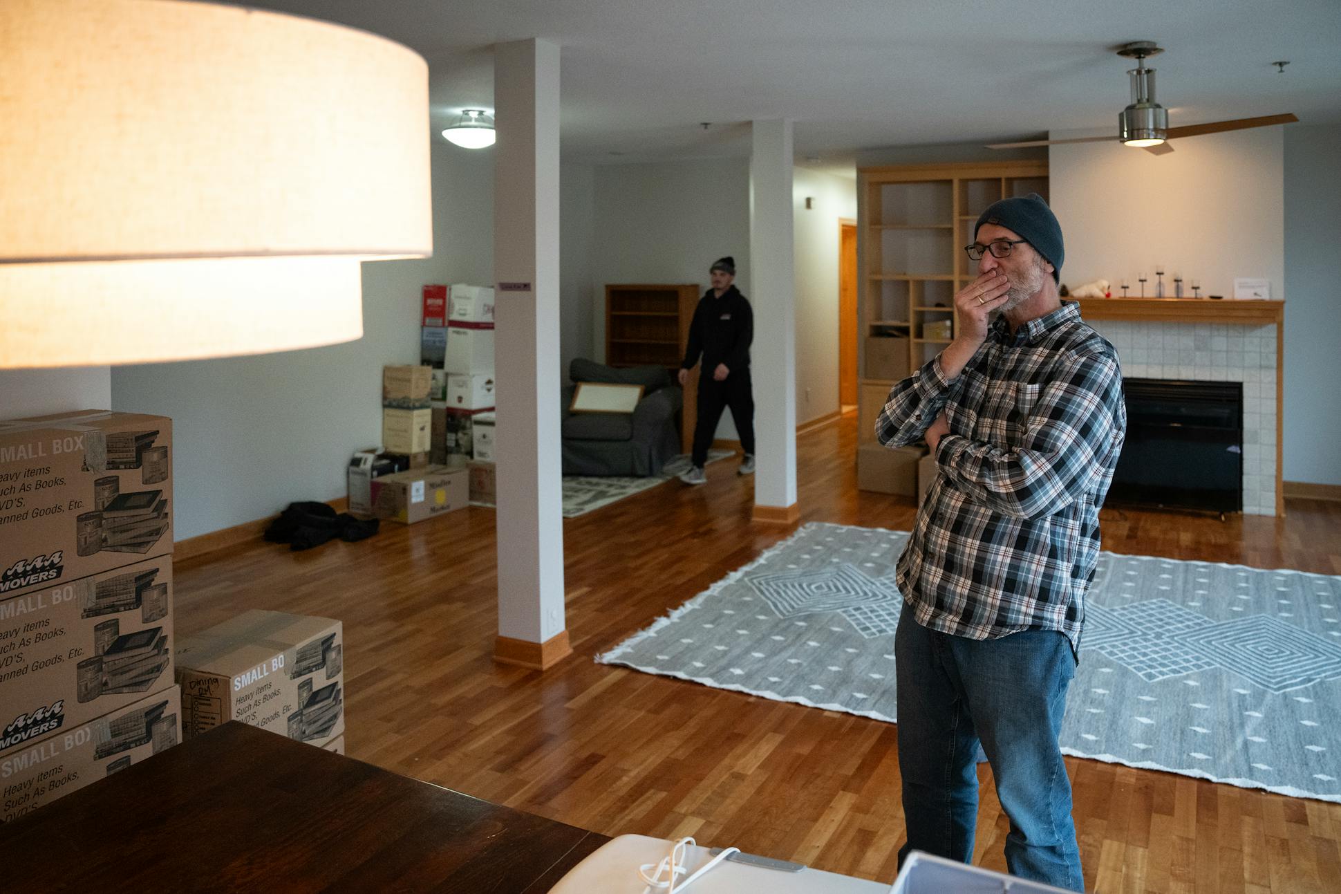 Dominic Papatola arranged furniture in his new home on Grand Avenue in St. Paul.