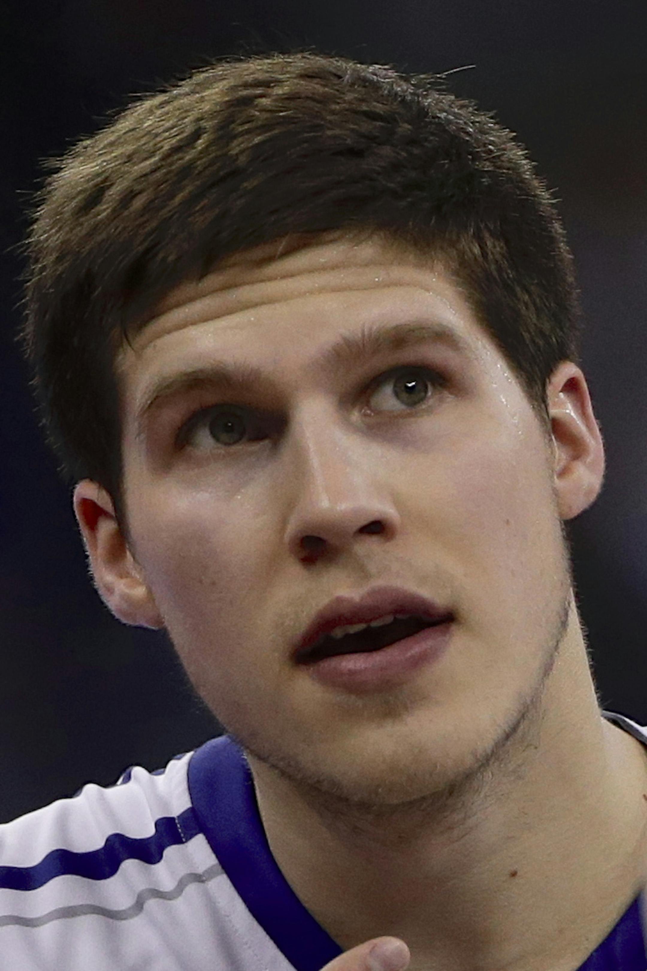 Creighton coach Greg McDermott looks at his notes with Doug McDermott (3) and Ethan Wragge (34) in the second half of an NCAA college basketball game against Seton Hall in Omaha, Neb., Sunday, Feb. 23, 2014. Creighton won 72-71. (AP Photo/Nati Harnik)