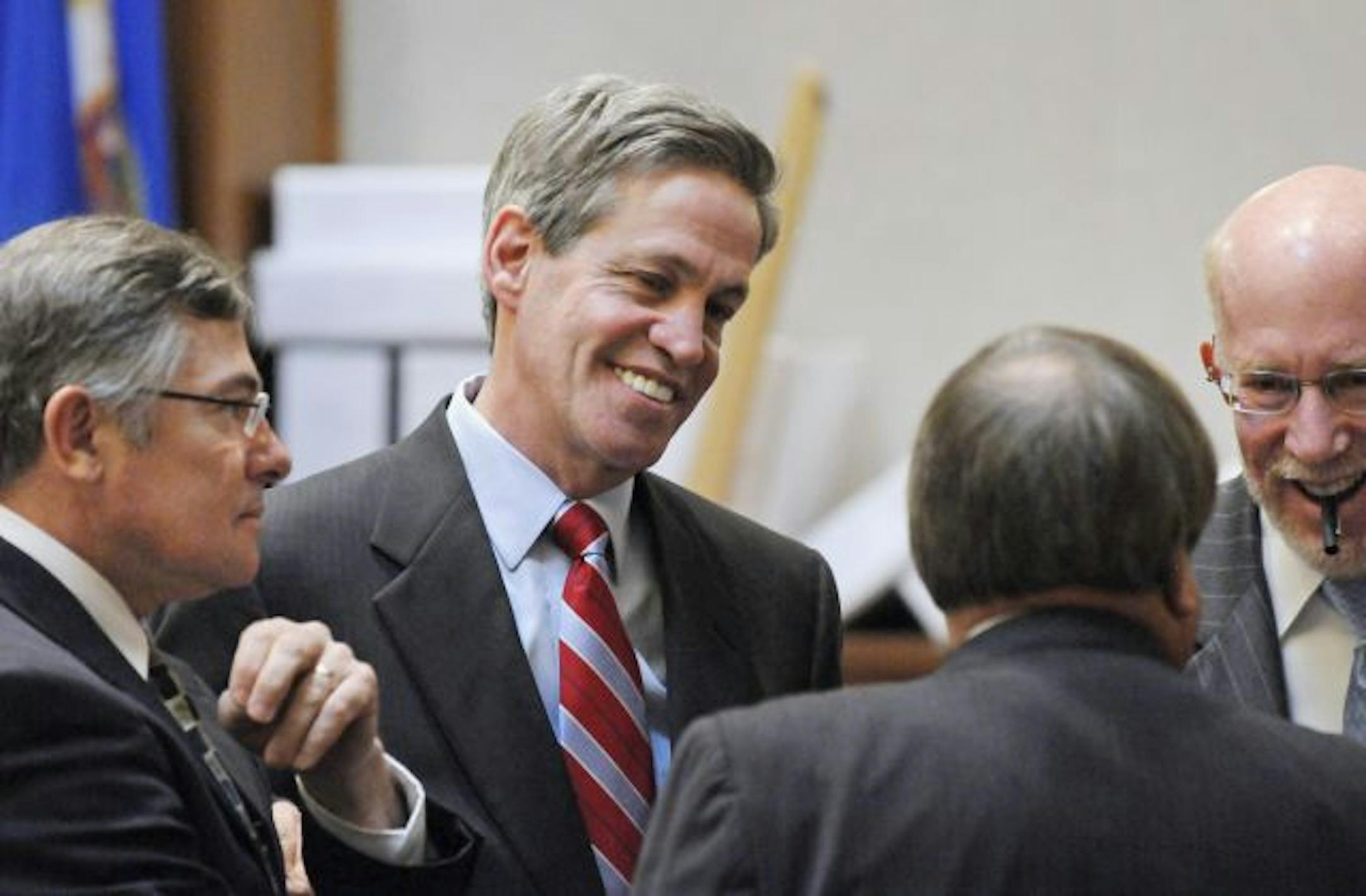 Norm Coleman appeared relaxed Thursday while meeting with attorneys Tony Trimble, left, Joe Friedberg, back to camera, and Ben Ginsberg during a break.