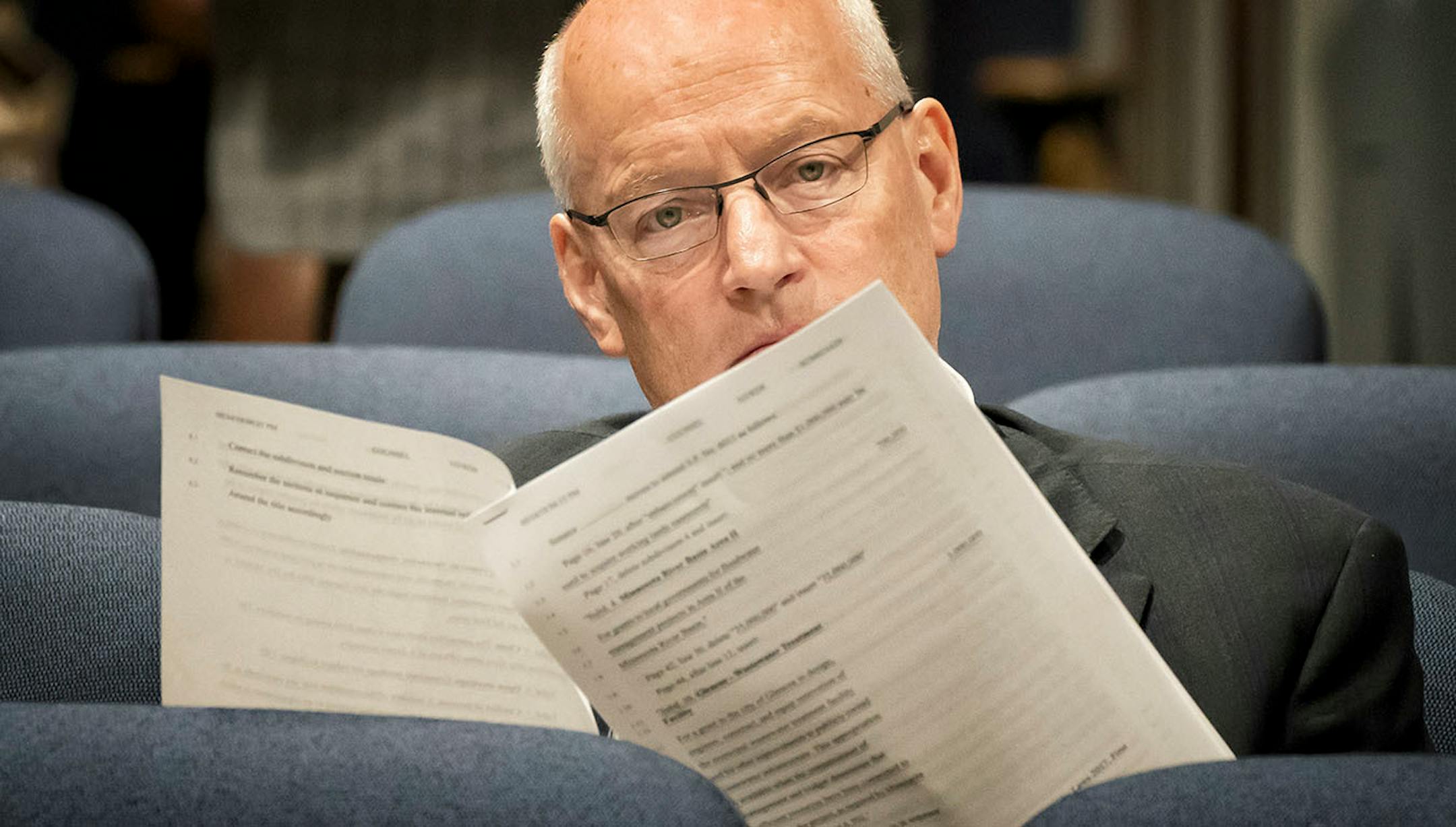 Commissioner Frans read over proposed changes to the bonding bill before testifying at an evening hearing of the Senate Finance Committee.