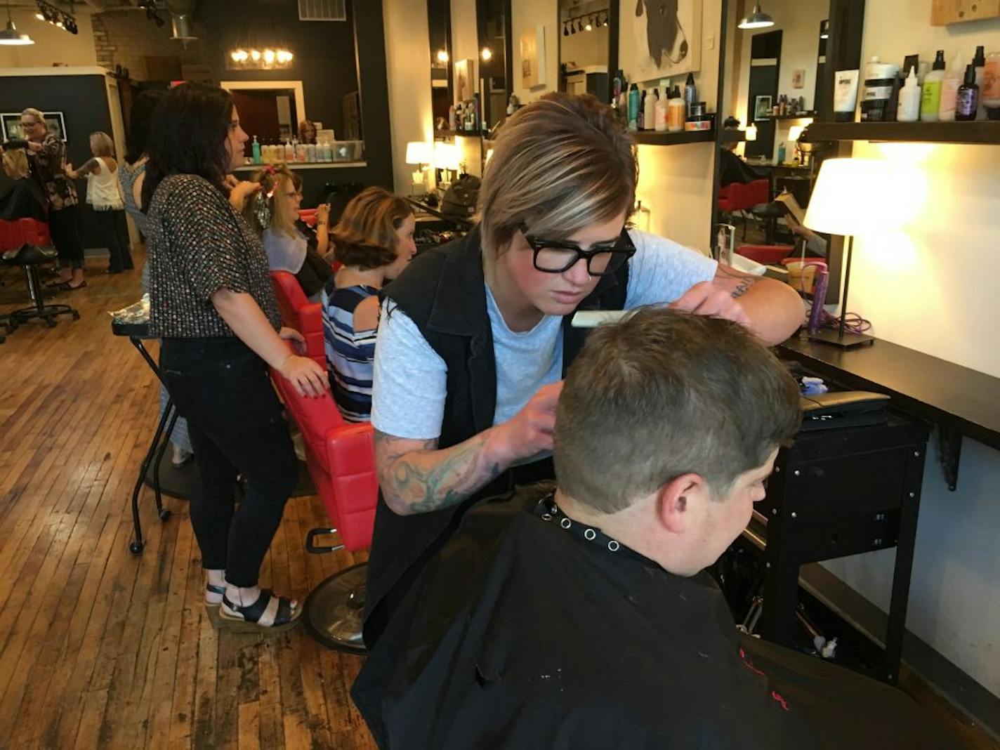 Owner Katie Steller, planning an expansion of her northeast Minneapolis salon in a former mattress factory, last week gave a complementary haircut to Rob Scott, regional director of the U.S. Small Business Administration. PHOTO: Neal.St.Anthony@startribune.com