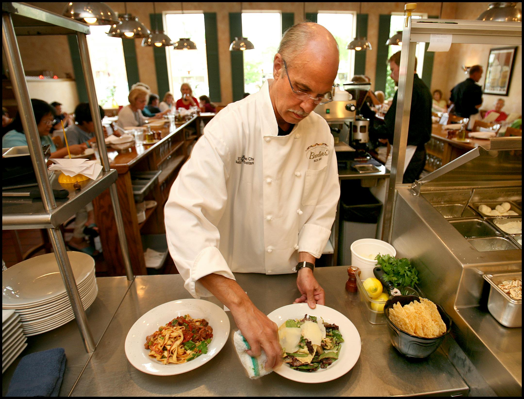 Chef Michael Rostance adds a finishing touch before sending out a plate at Broders' Pasta Bar. The restaurant offers dinner for two for $26 every Sunday through Thursday evening after 8 p.m