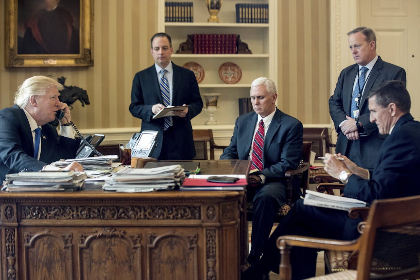 FILE - In this Jan. 28, 2017, file photo, President Donald Trump accompanied by, from second from left, Chief of Staff Reince Priebus, Vice President Mike Pence, White House press secretary Sean Spicer and National Security Adviser Michael Flynn speaks on the phone with Russian President Vladimir Putin in the Oval Office at the White House in Washington. Flynn resigned as President Donald Trump's national security adviser Monday, Feb. 13, 2017. (AP Photo/Andrew Harnik, File)