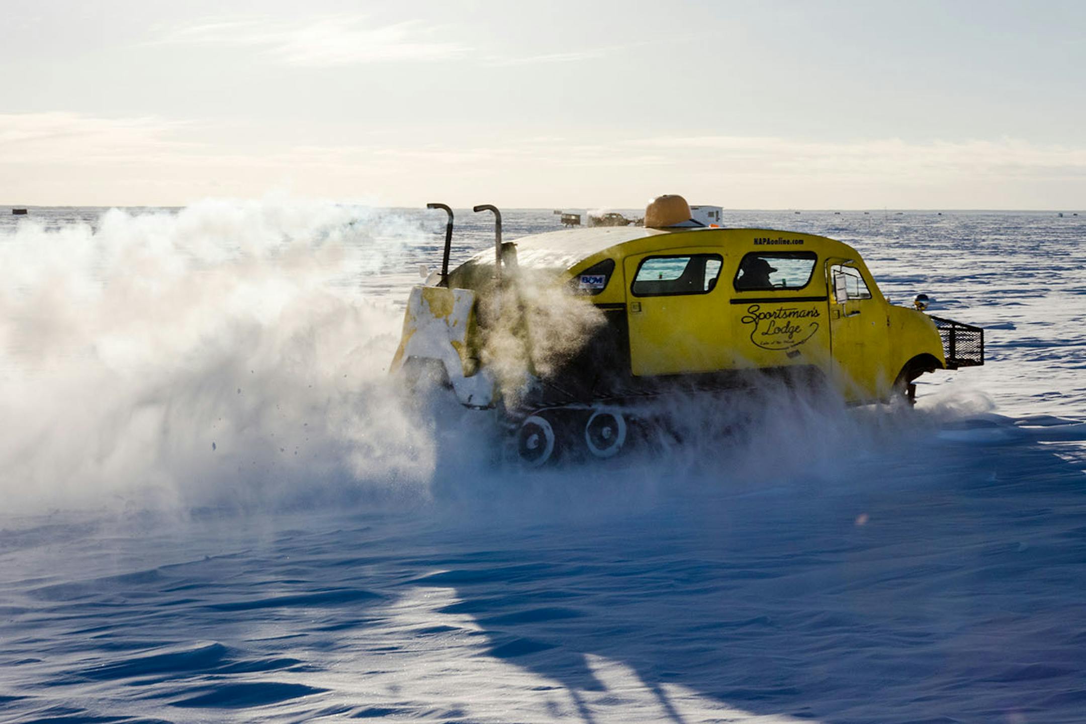 Shane Burk cruises across the snow covered ice in his bombardier. When guides drive off the groomed trials on the lake they call it "Baja."