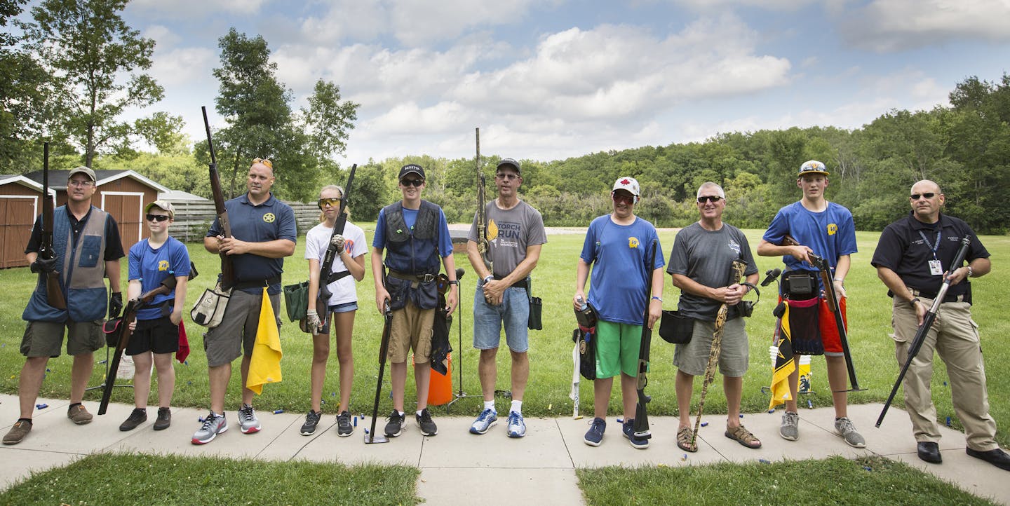 Members of the Plymouth Police and Wayzata High School students wait to receive their scores after posing for a photo with each other after a friendly trap shooting competition. ] (Leila Navidi/Star Tribune) leila.navidi@startribune.com BACKGROUND INFORMATION: The Wayzata High School Trap Team paired up with the Plymouth Police on Tuesday, August 9, 2016 for some friendly trap shooting at the Plymouth Gun Club. In Minnesota, trap shooting is the fastest growing high school sport, with nearly 9,0