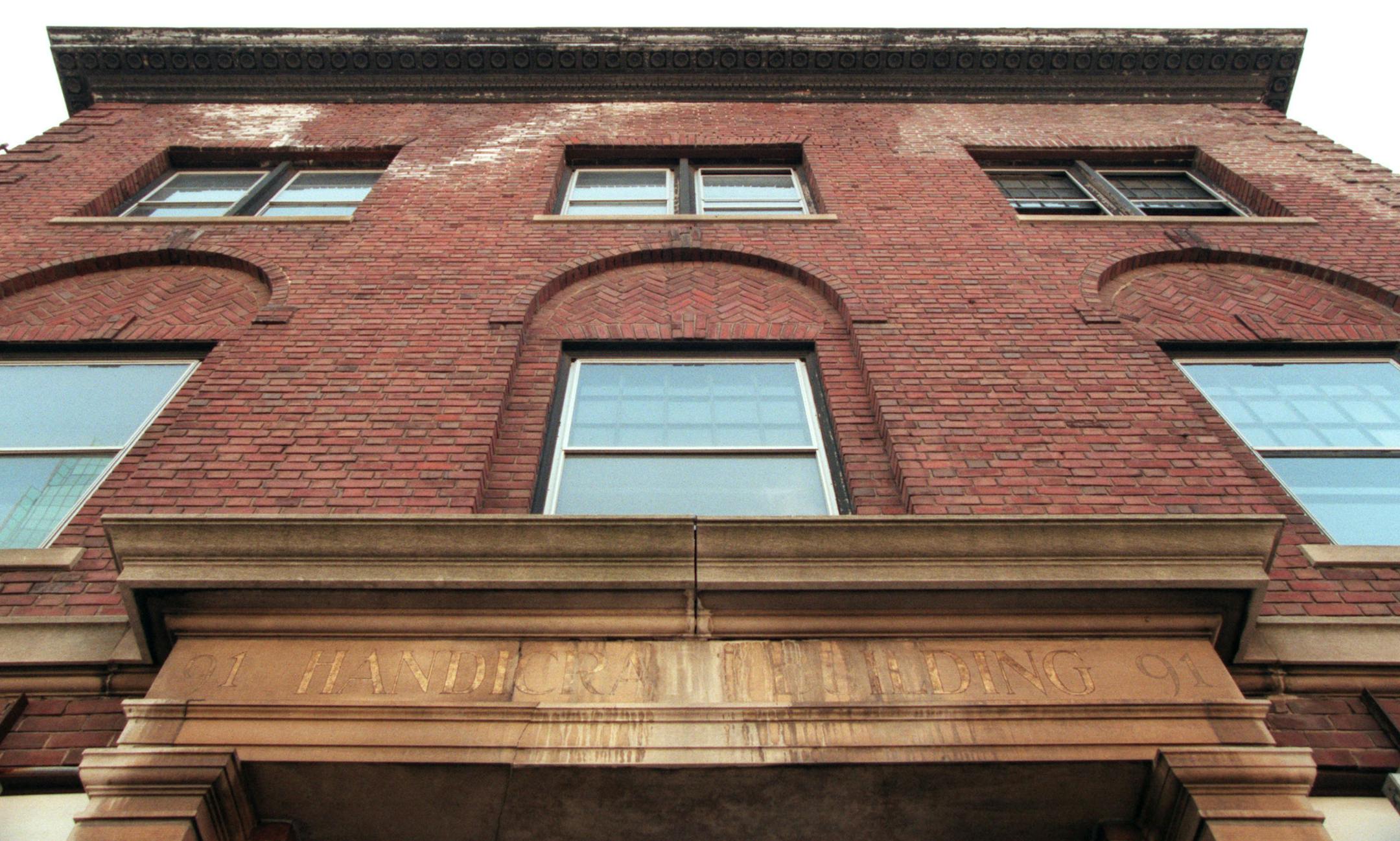Handicraft Guild Building at the corner of 10th and Marquette is historic. -- Looking up at the stonework on original building.