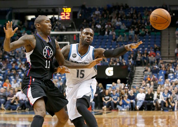 Timberwolves forward Shabazz Muhammad passed to a teammate, away from Clippers guard Jamal Crawford during the first half Wednesday night.