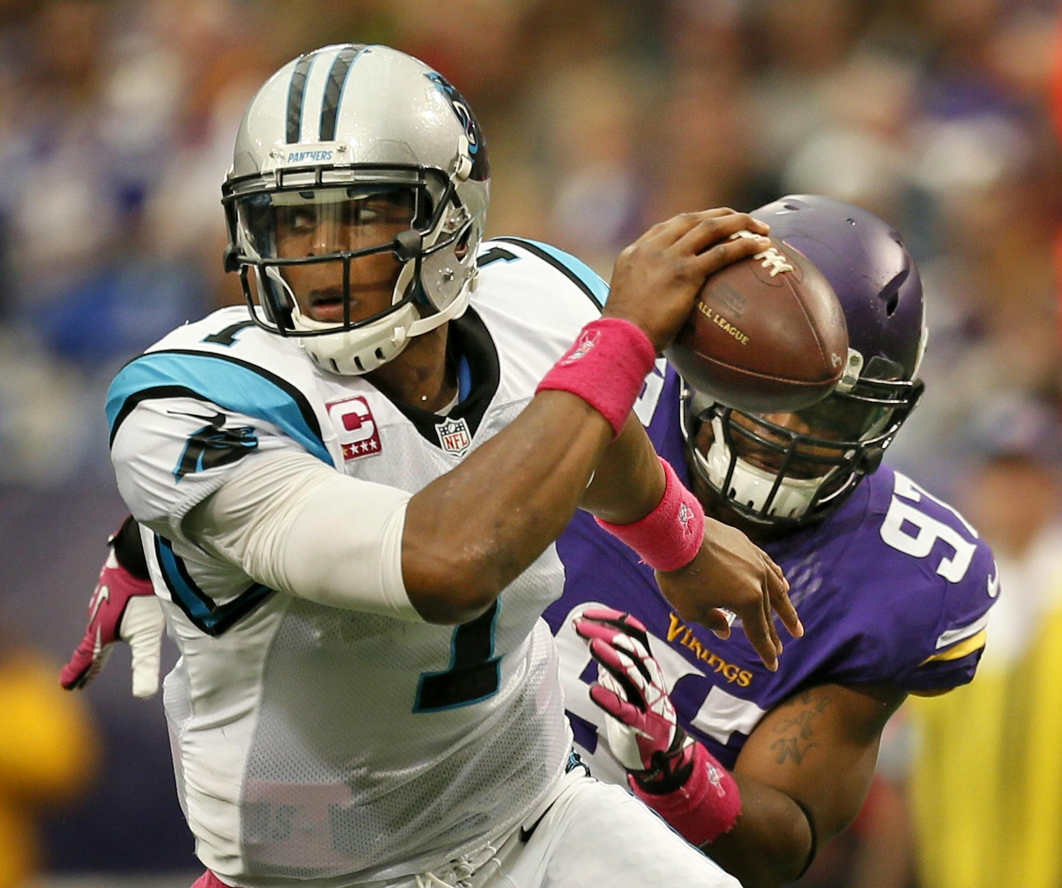 Carolina quarterback Cam Newton scrambled away from Vikings defensive end Everson Griffen in the first half.