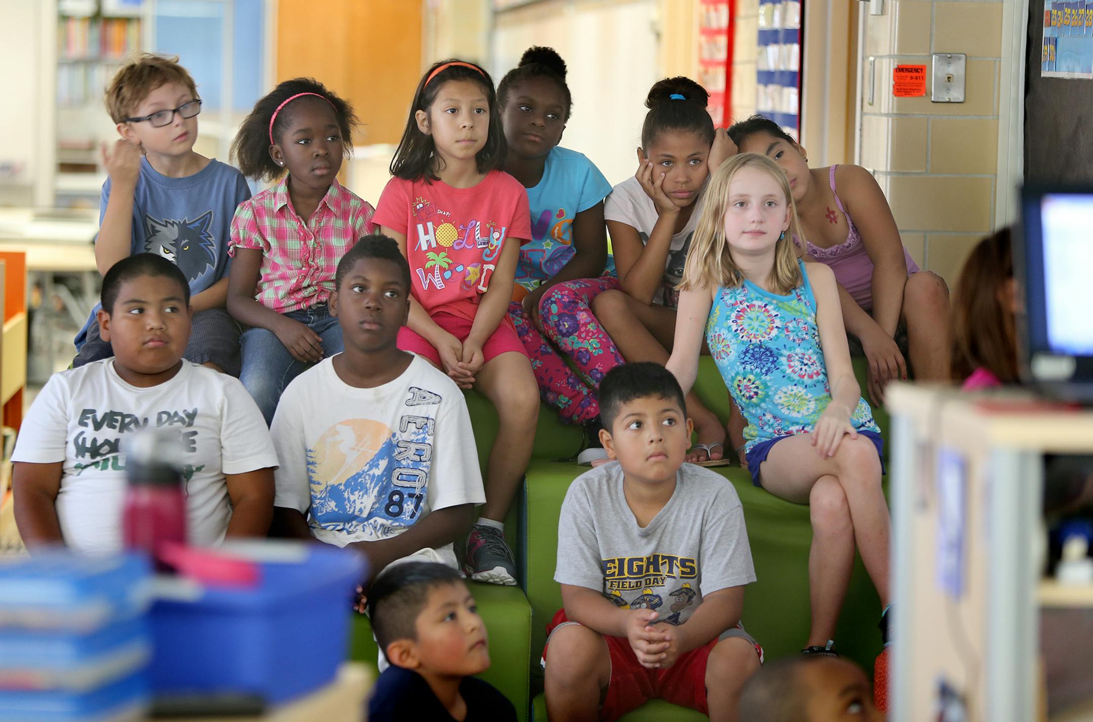 Desirae Gillis' third-graders gathered on comfortable stadium-like seats to listen to their teacher at North Park Elementary School in Fridley, MN, Friday, September 6, 2013. The school's principal Jeff Cacek is now changing the century-old model of how a classroom used to be to a modern era classroom. The design is one large space where there are no desks for any of the students or teachers. It's sparsely furnished with tables and stools and is separated by a glass partition. (ELIZABETH FLORES/