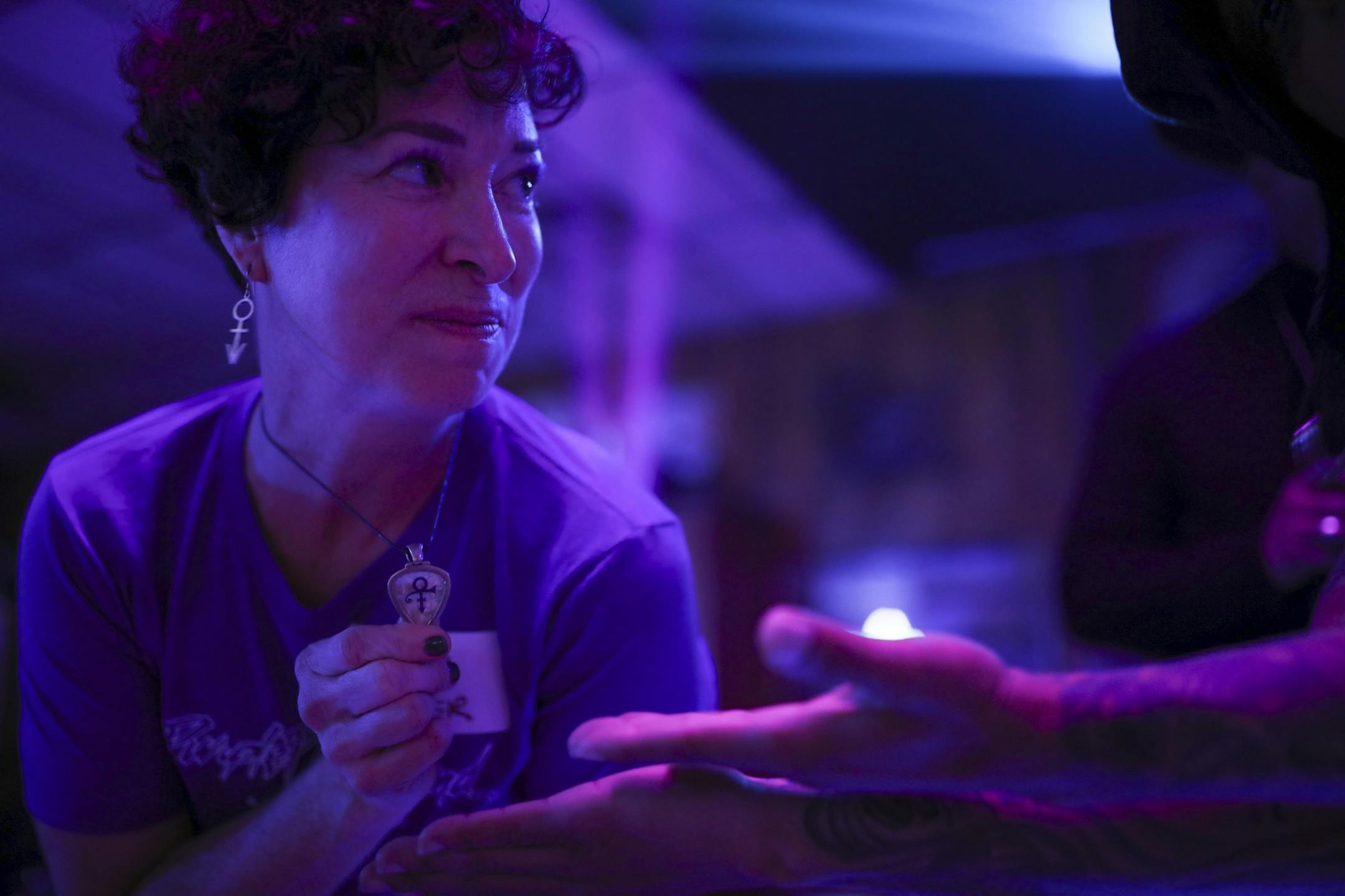 Heidi Vader showed a guitar pick she got at a Prince concert that she had made into a necklace while on the dance floor at her organization's "Free Urself Dance Party" Wednesday night.