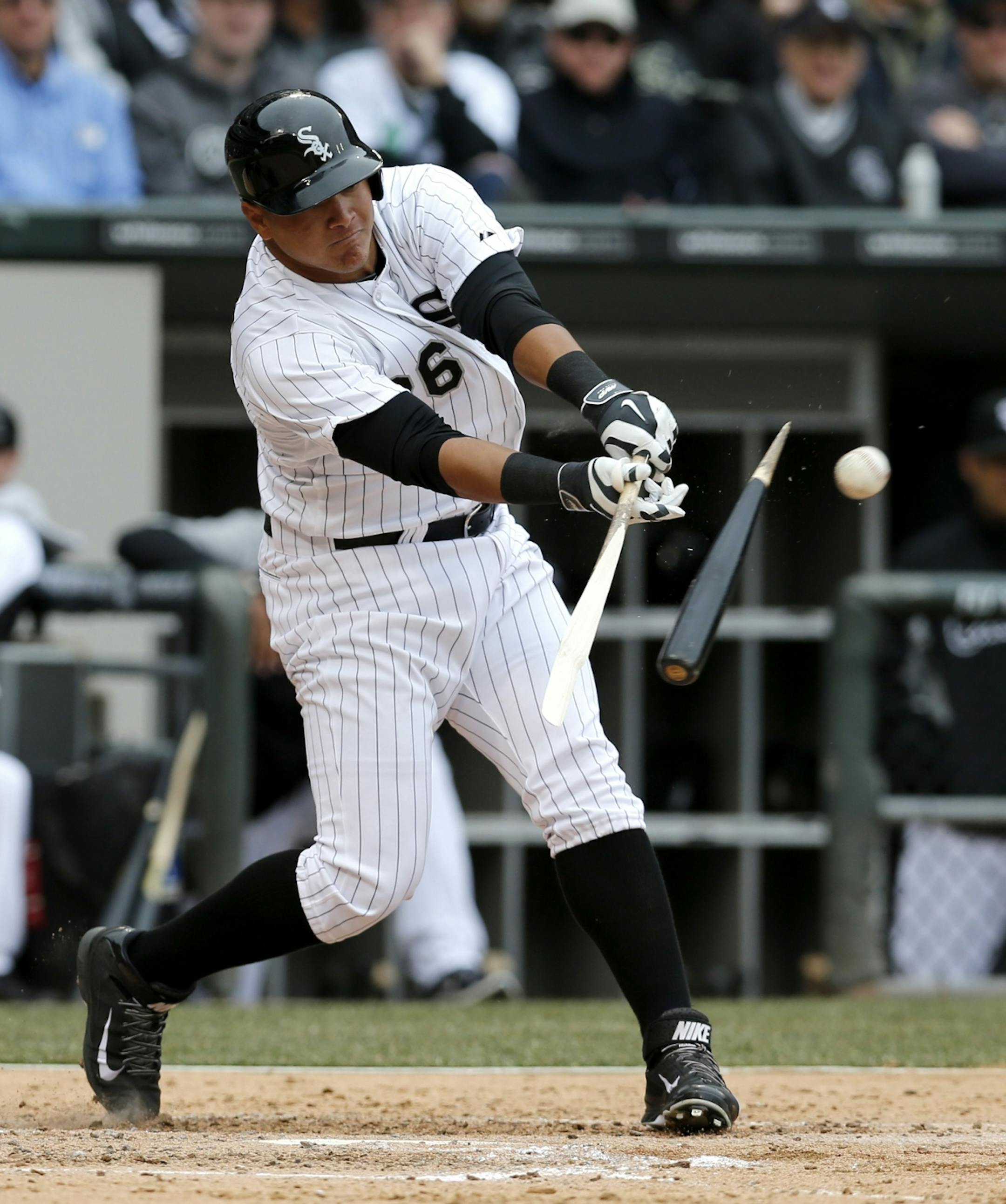 Chicago White Sox right fielder Avisail Garcia hits a broken bat single off Minnesota Twins starting pitcher Ricky Nolasco during the third inning of an Opening Day baseball game Monday, March 31, 2014, in Chicago. The White Sox won 5-3.