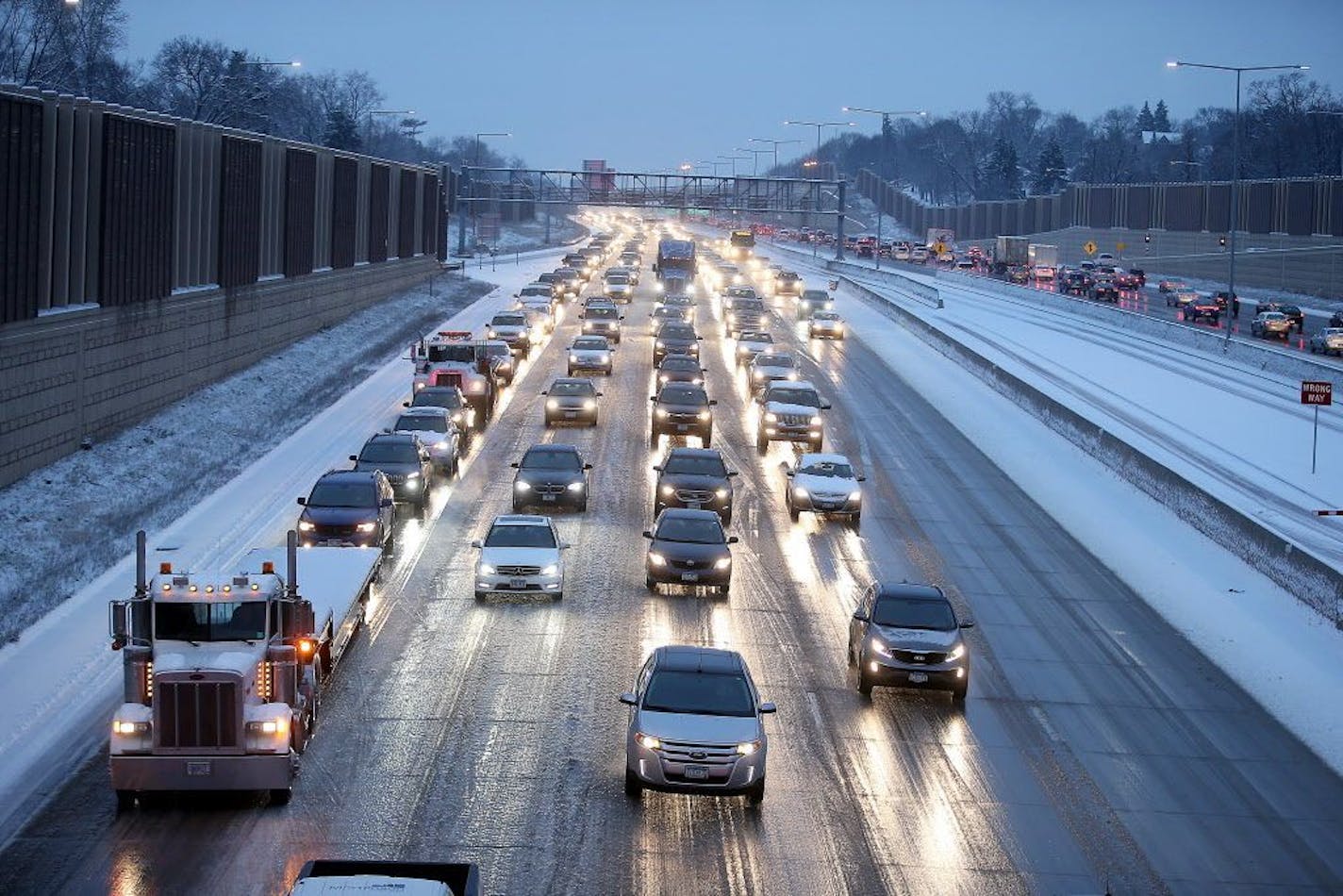 Morning traffic made its way into downtown during the first snowfall of the season, Monday, November 30, 2015 in Minneapolis.