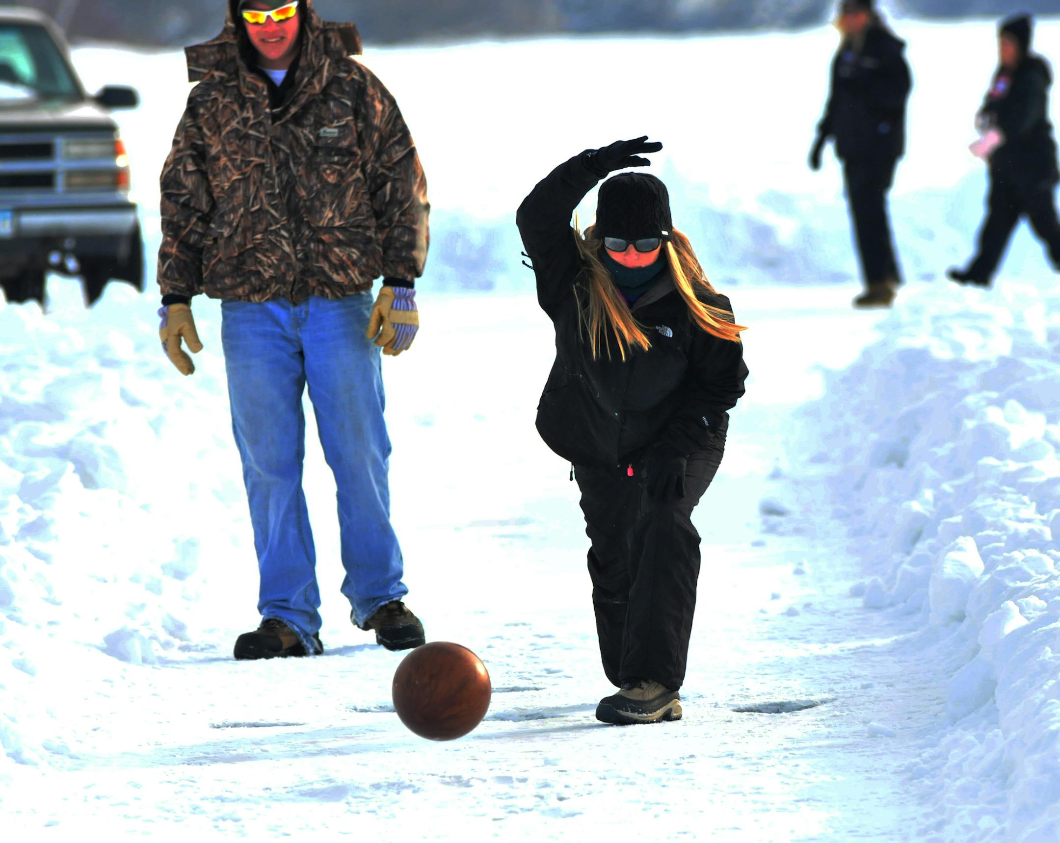 Sauk Centre resident Katie Determan takes part in the annual tradition of ice bowling on Sauk Lake in Sauk Centre, Minn. PHOTO BY BRYAN ZOLLMAN, SAUK CENTRE HERALD