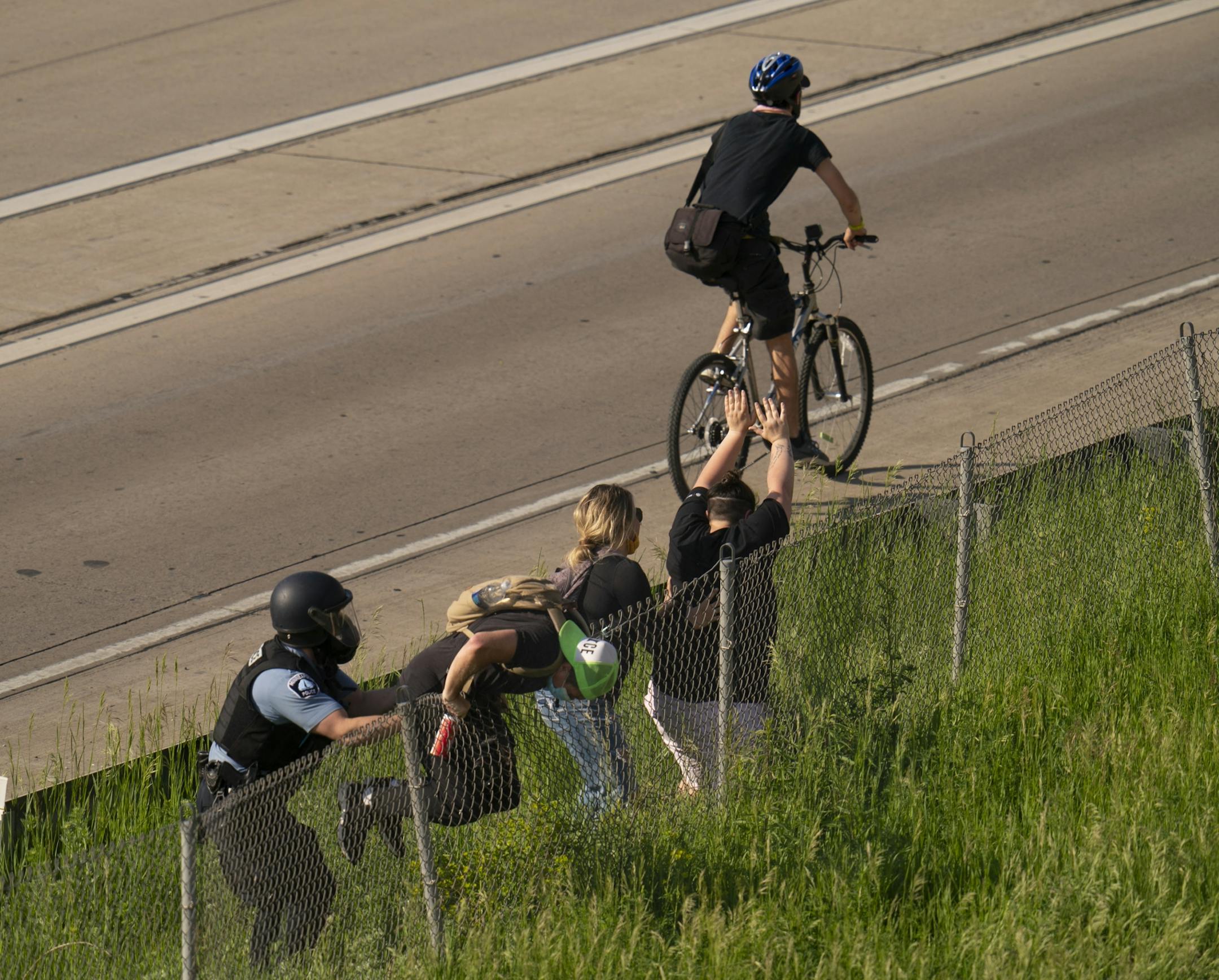 Police tried to clear the freeway of protesters after they arrived on the Interstate 35W bridge on Sunday.