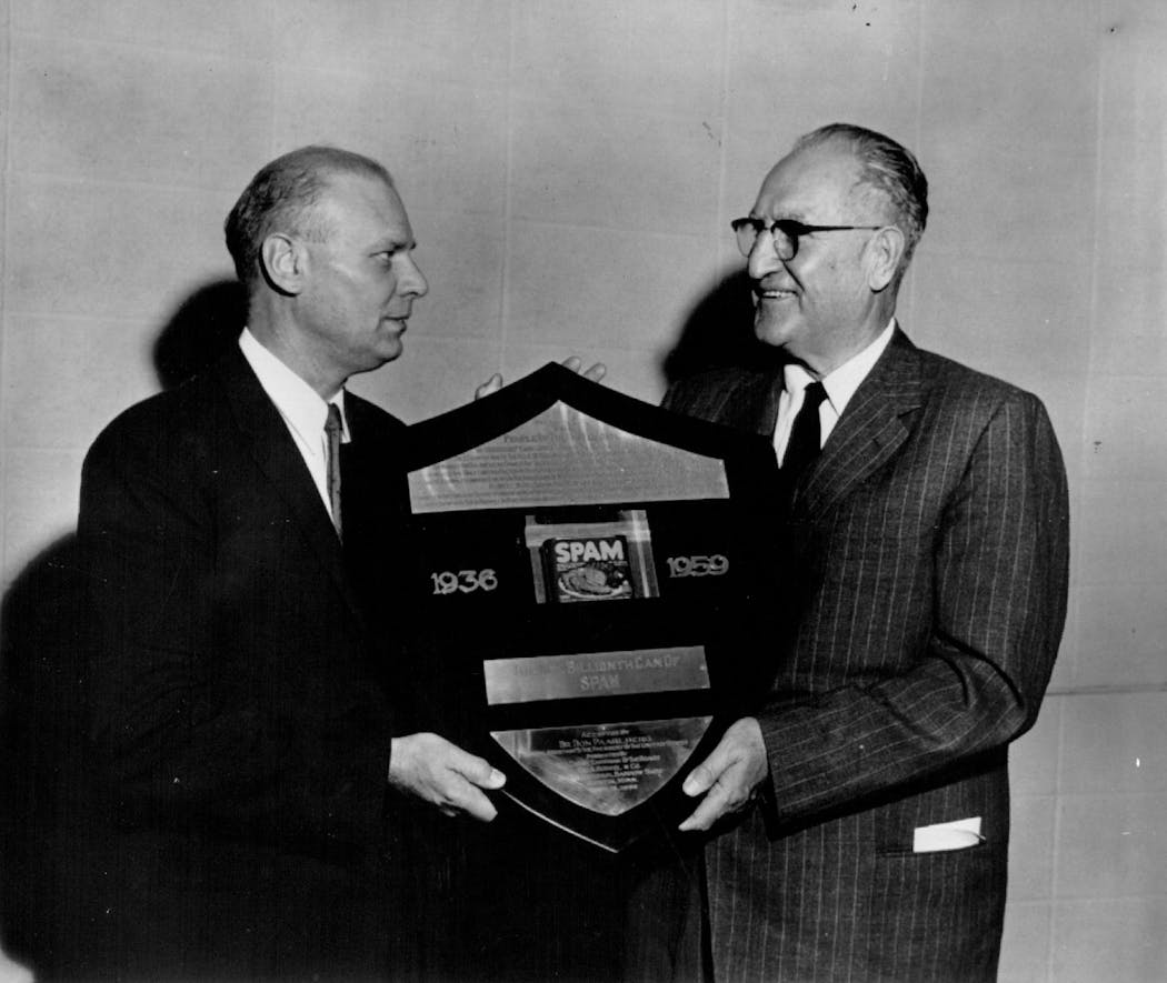 Hormel's board chairman, right, presents a plaque to a representative of the Eisenhower administration, left, commemorating the one billionth can of Spam.