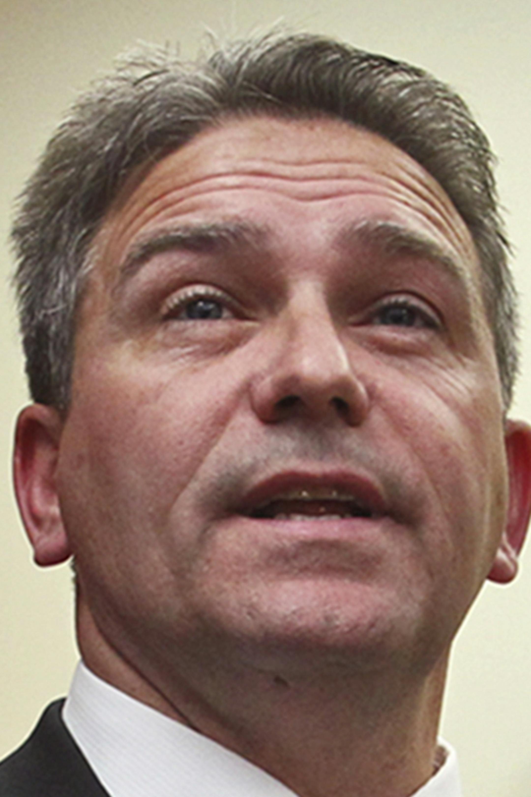 FILE - In this Nov. 30, 2012, file photo, Minnesota State-Mankato football coach Todd Hoffner speaks to reporters at a news conference in Mankato, Minn., as his wife Melodee looks on. Hoffner, who was caught up and later cleared in a child pornography investigation in Minnesota, is the new head coach at Minot State University in North Dakota. Hoffner will succeed Paul Rudolph, who resigned on Jan. 2 after seven seasons to become the offensive coordinator at the University of North Dakota. (AP Ph