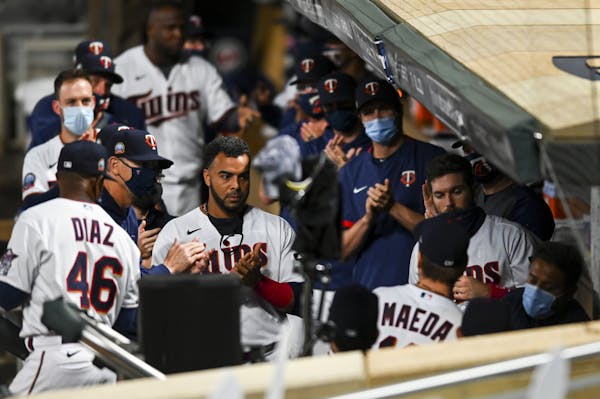 Teammates applauded Minnesota Twins starting pitcher Kenta Maeda (18) after he returned to the dugout after his no hitter was broken up in the top of 