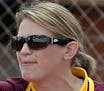 Minnesota head coach Jessica Allister, right, celebrates with Sara Groenewegen (17) in the fourth inning during an NCAA college softball tournament re