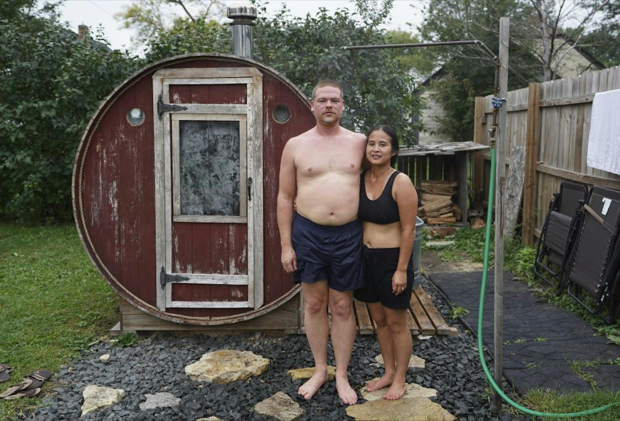 Christopher and Julie Rice outside their neighbor's barrel sauna.