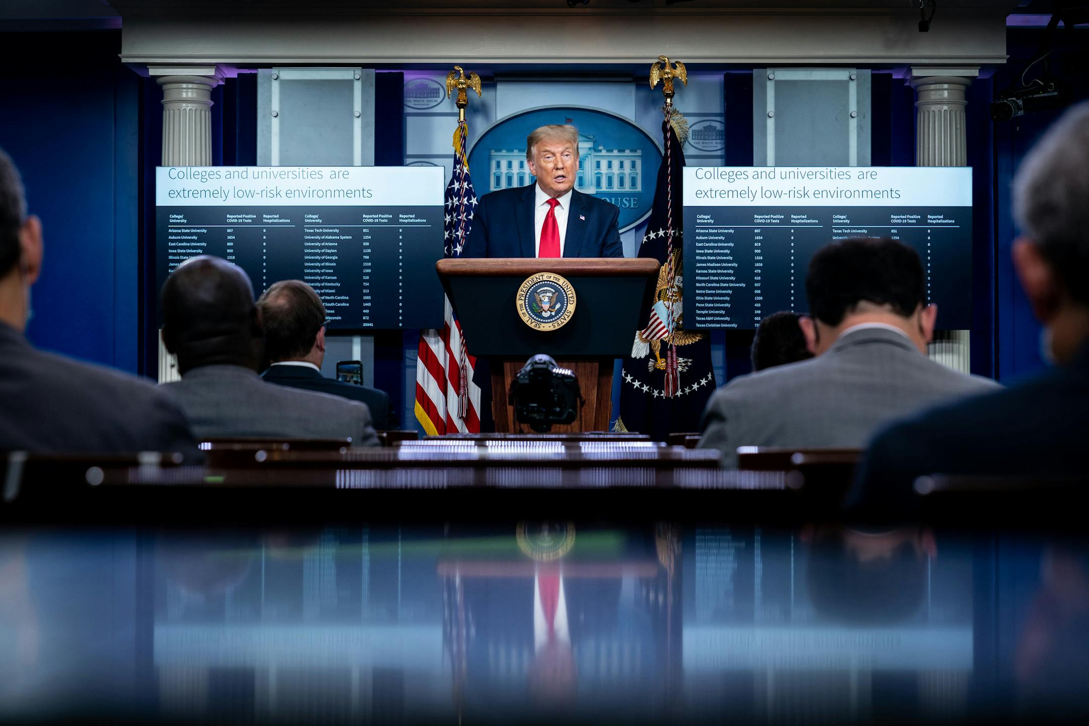 President Donald Trump addresses a news conference at the White House in Washington, Thursday, Sept. 10, 2020, with graphics that reflect COVID-19 numbers at particular colleges and universities. (Erin Schaff/The New York Times)