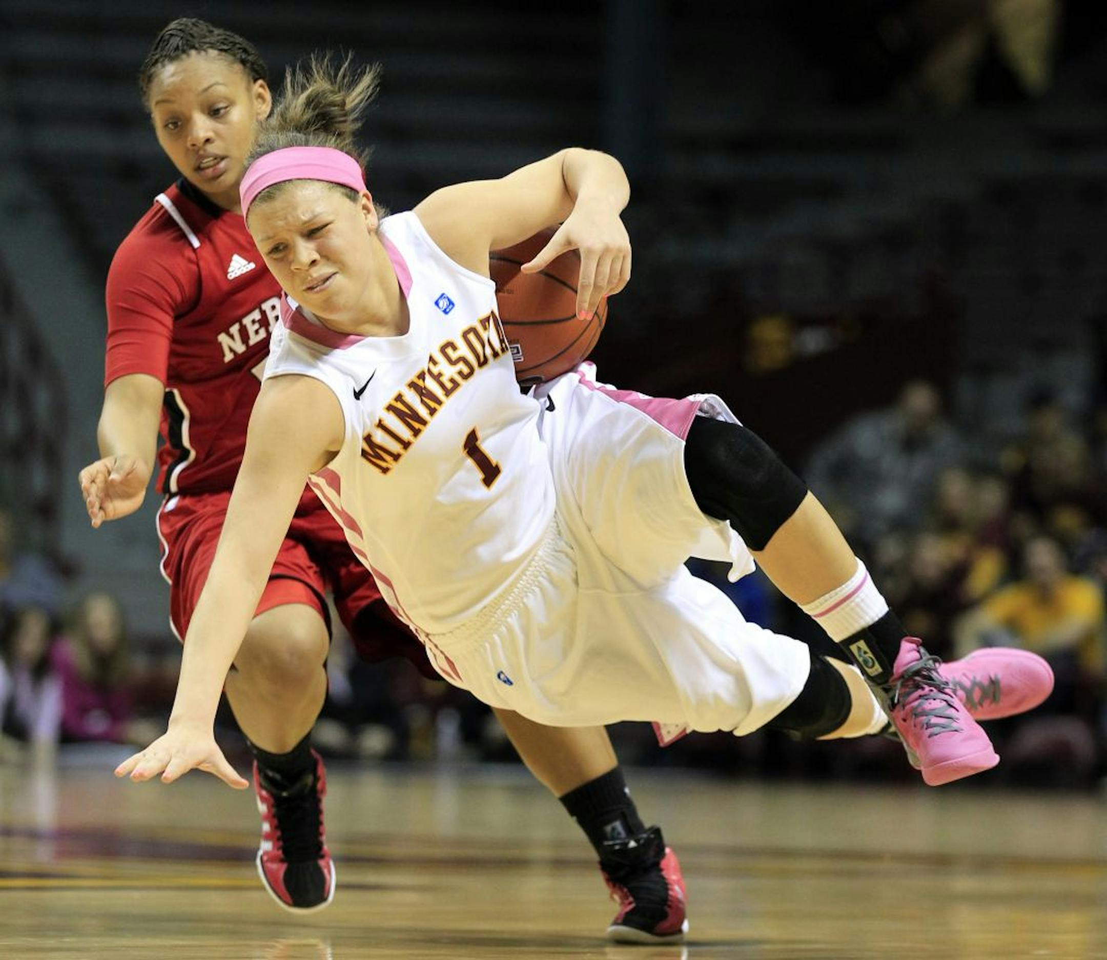 Rachel Banham (1) of Minnesota was fouled by Brandi Jeffery (13) of Nebraska in the first half of a women's college basketball game on Monday, February 13, 2012, at Williams Arena in Minneapolis, Minnesota.