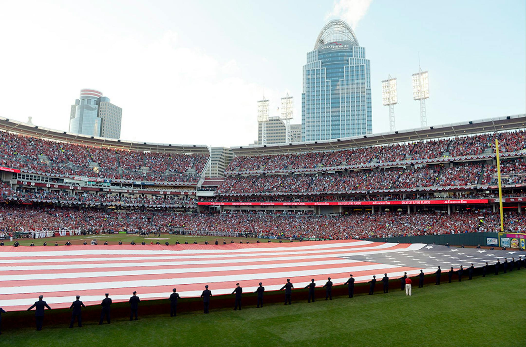 An American flag is stretched across the field beforethe MLB All-Star baseball game, Tuesday, July 14, 2015, in Cincinnati.