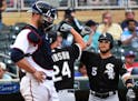 Chicago White Sox's Matt Davidson is congratulated by Yolmer Sanchez after hitting a solo home run against the Minnesota Twins during the ninth inning