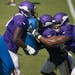 Vikings tackle Olisaemeka Udoh (74) pushed back against Rashod Hill (69), right, and another player during a drill Monday afternoon.