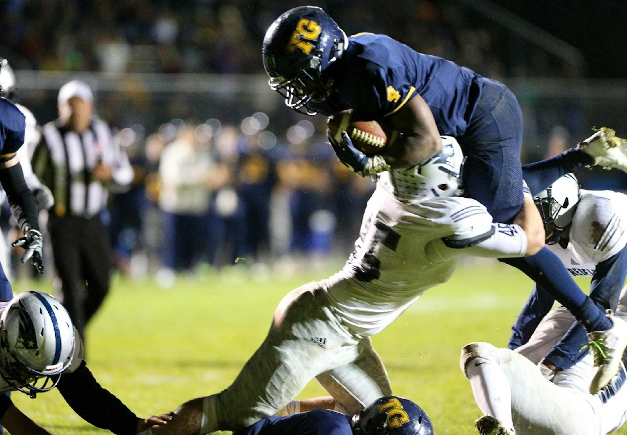 Totino-Grace running back Gayflor Flomo jumped over a Champlin Park defender to score for the Eagles in their victory over Champlin Park in early October.