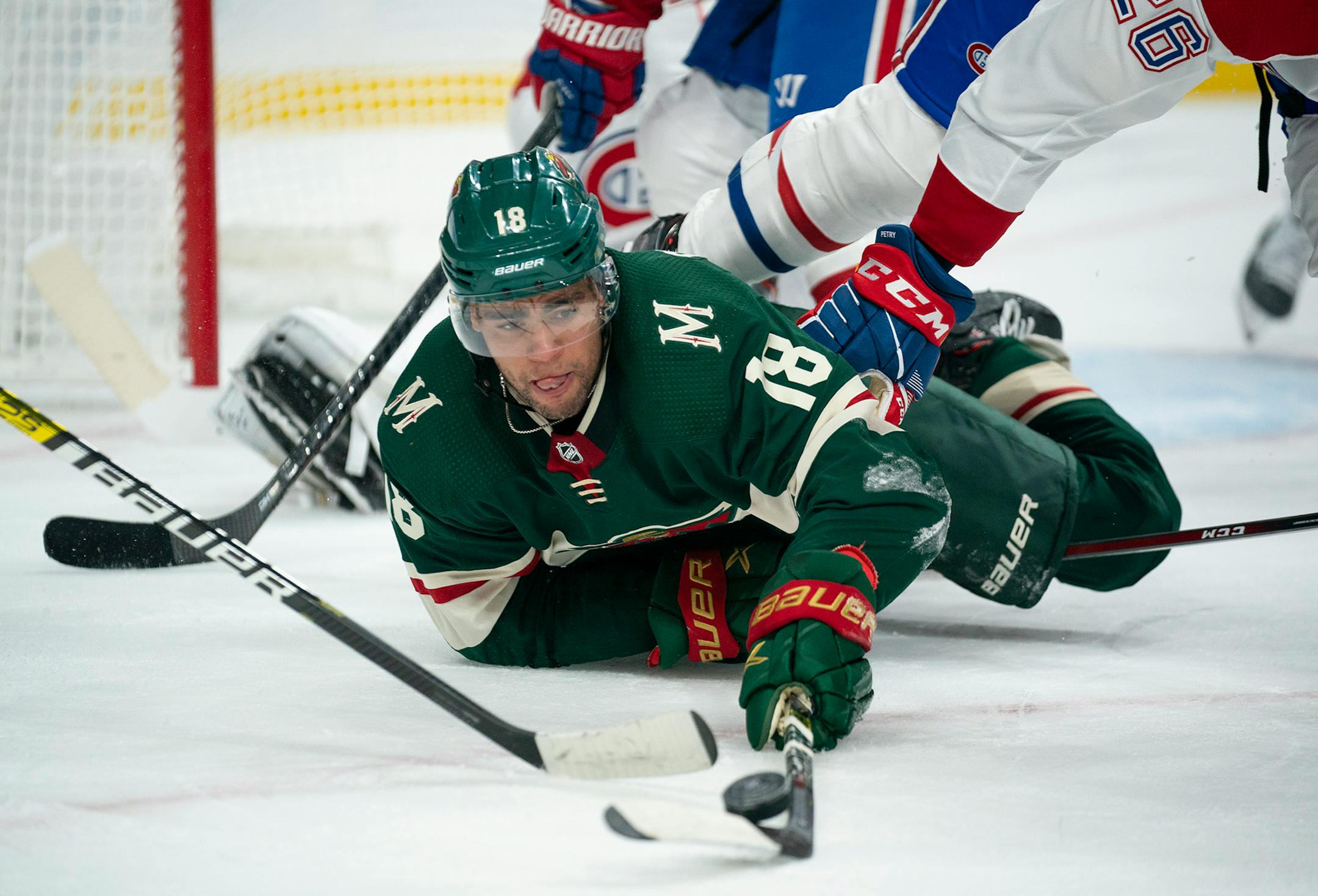 Wild left winger Jordan Greenway kept control of the puck after dropping to the ice in the first period against the Canadiens on Sunday.