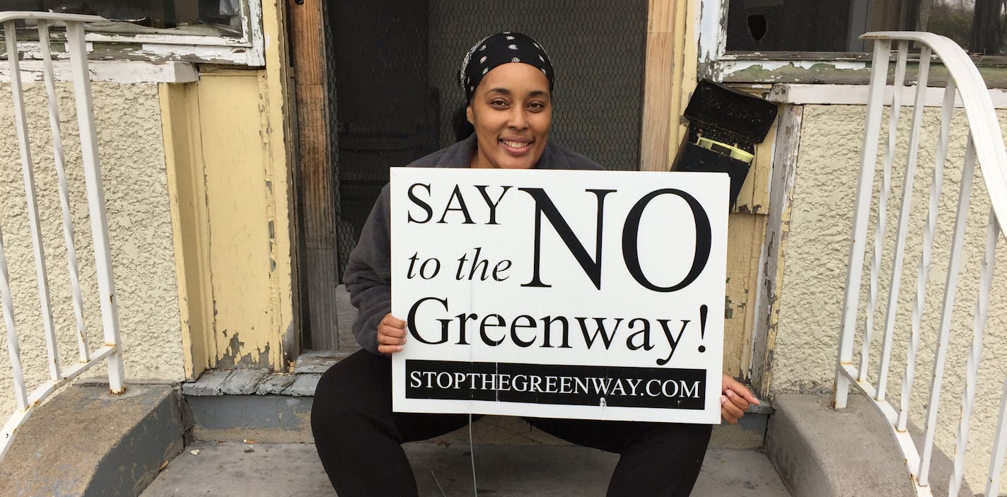 Sunnie Mills with the &#xee;Say No to the Greenway&#xee; sign said that when there planters sitting out on her block on Irving Av. N. she couldn&#xed;tpark in front the house. &#xec;I hate the Greenway,&#xee; she says. credit: Randy Furst - Star Tribune