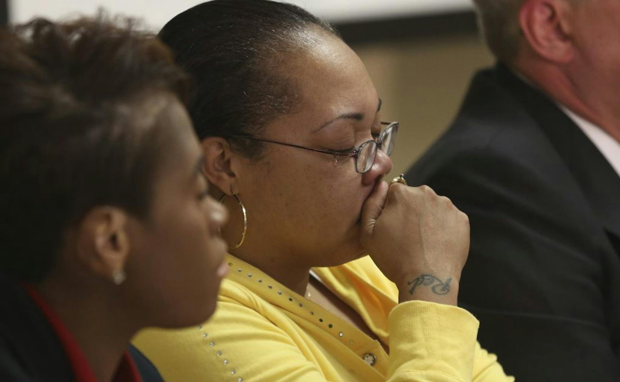 Sheila O'Neal , mother of Terrance Franklin, who was shot and killed by police, teared up as the family's lawyer Michael Padden, right, addressed the media during a press conference at the a Min., Thursday, May 30, 2013.