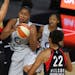 The Lynx's Damiris Dantas, center, grabs a rebound between Las Vegas Aces' Dearica Hamby (5) and A'ja Wilson (22) during the first half