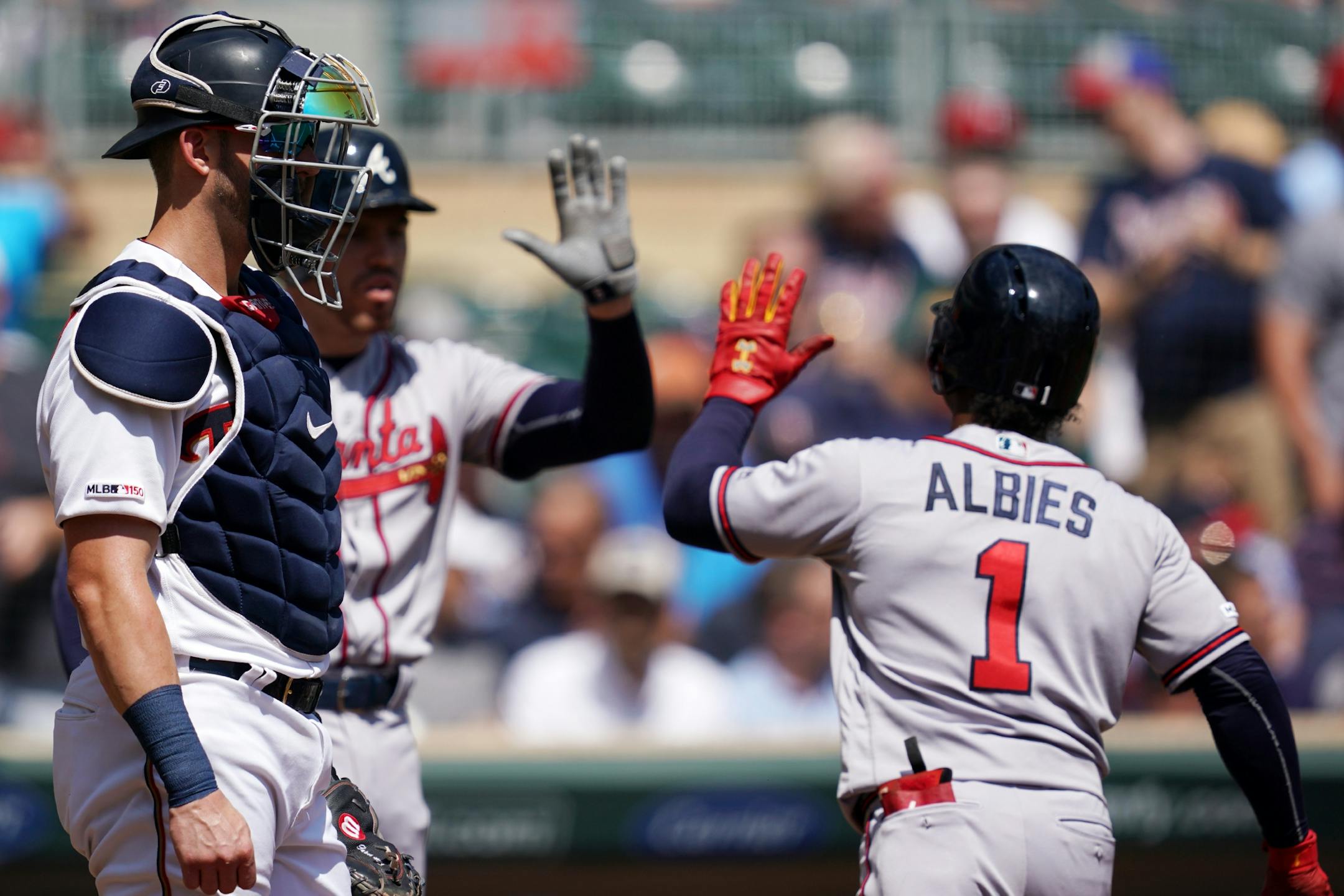 Minnesota Twins catcher Mitch Garver (18) stood on the mound as Atlanta Braves second baseman Ozzie Albies (1) passed home after hitting a solo home run in the first inning.