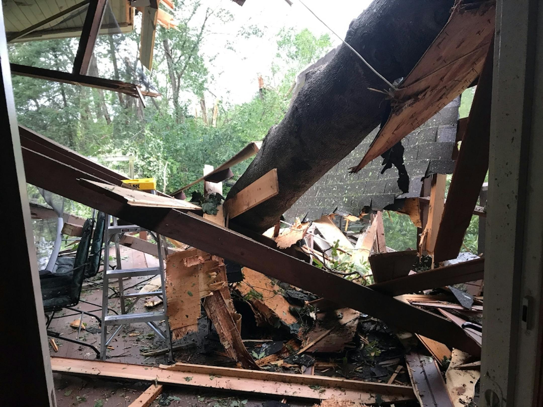 A century-old oak tree fell on Katie Engelmann's farm house outside of Northfield during Thursday's storms, creating a gaping hole in the living room. It was the latest in hard luck for the family which had just recovered from a house fire.