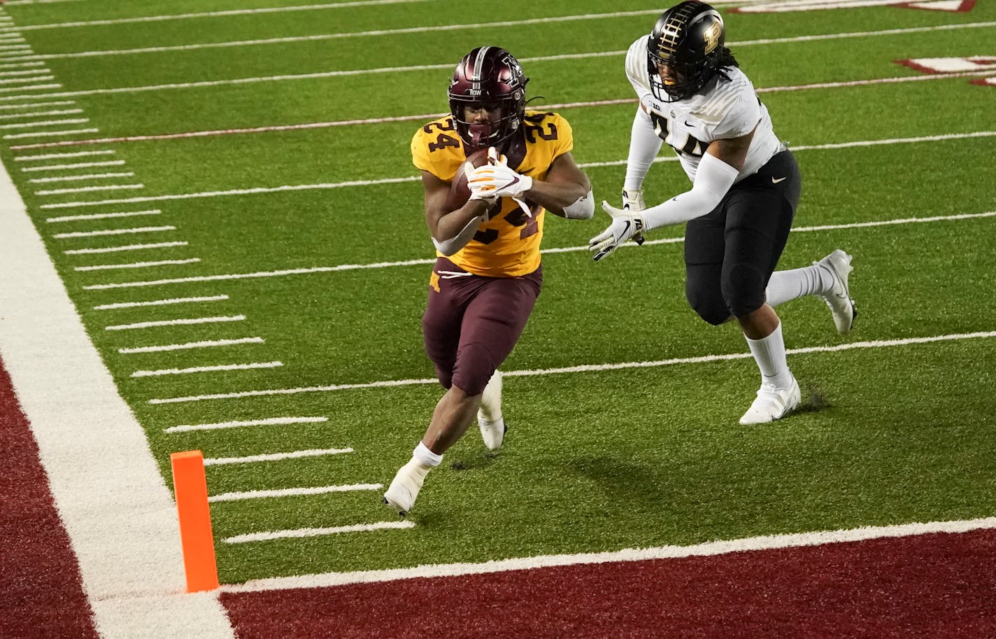 Gophers running back Mohamed Ibrahim runs into the end zone for a touchdown against Purdue linebacker Kydran Jenkins in the second half.