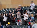 Fans reach for a foul ball hit by Minnesota Twins third base Jose Miranda in the second inning. The Minnesota Twins faced the Los Angeles Dodgers in a