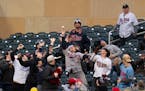 Fans reach for a foul ball hit by Minnesota Twins third base Jose Miranda in the second inning. The Minnesota Twins faced the Los Angeles Dodgers in a