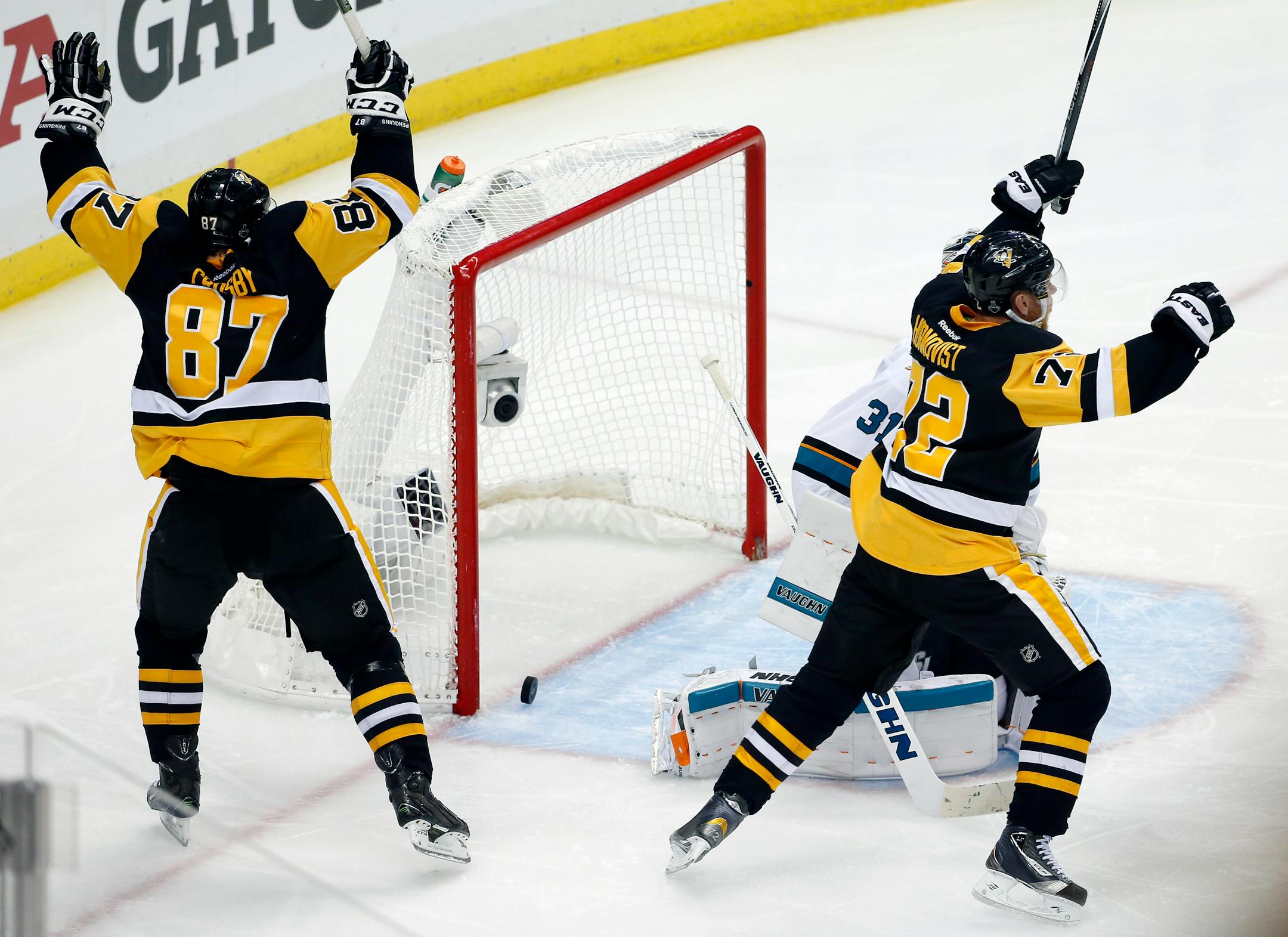 Pittsburgh Penguins' Sidney Crosby (87) and Patric Hornqvist, right, celebrate a goal by Conor Sheary against San Jose Sharks goalie Martin Jones (31) during overtime in Game 2 of the NHL hockey Stanley Cup Finals on Wednesday, June 1, 2016, in Pittsburgh. The Penguins won 2-1 to take a 2-0 lead in the series. (AP Photo/Gene J. Puskar)