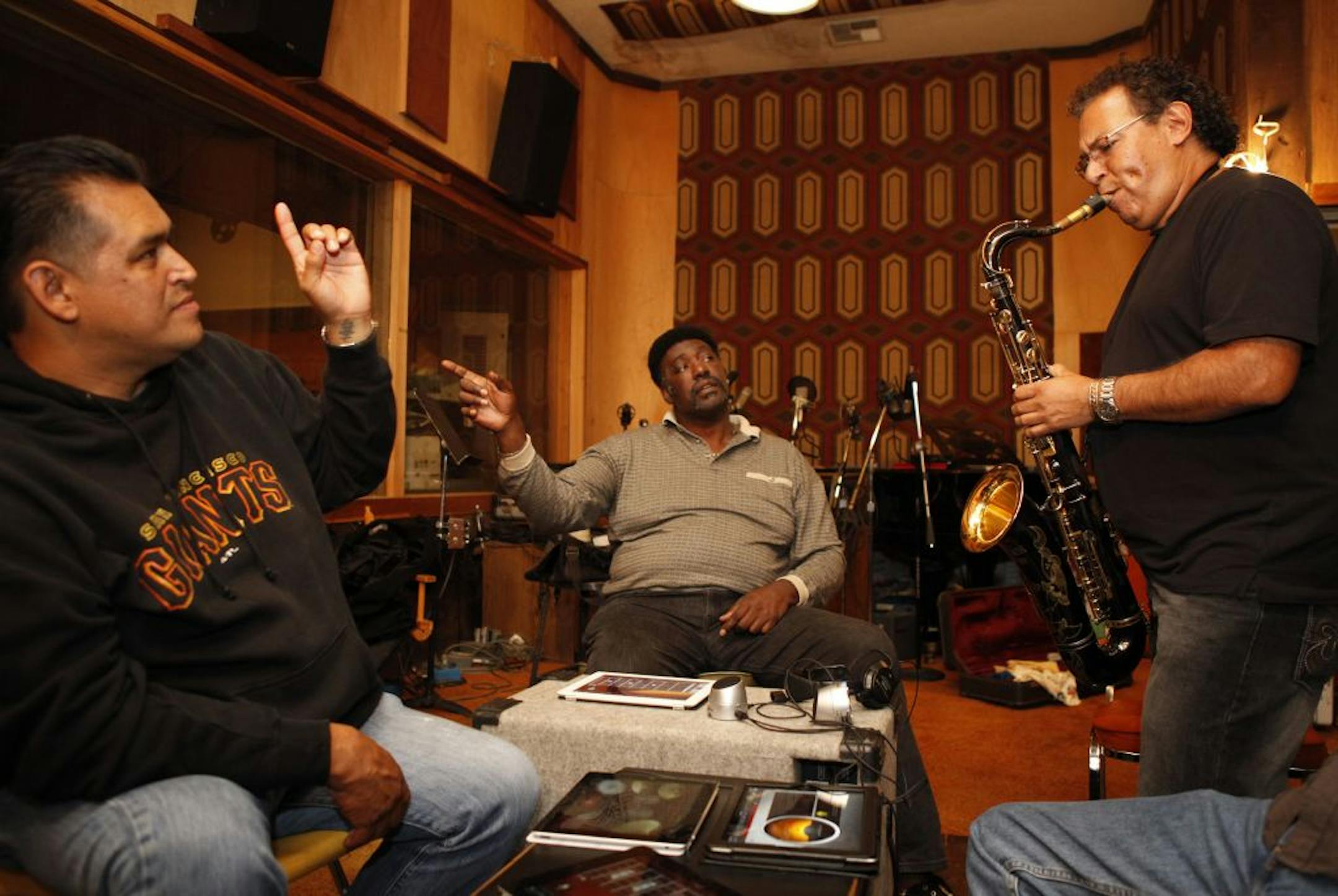 Drummer Donnie Green, left, guitarist J.C. Smith, center, and saxophone player Abraham Vasquez, right, lay down a track while testing out the new Jam Session feature of the GarageBand iPad app at Tiki Studios-O&apos;Neal Productions in San Jose, Calif., on Monday, June 4, 2012.
