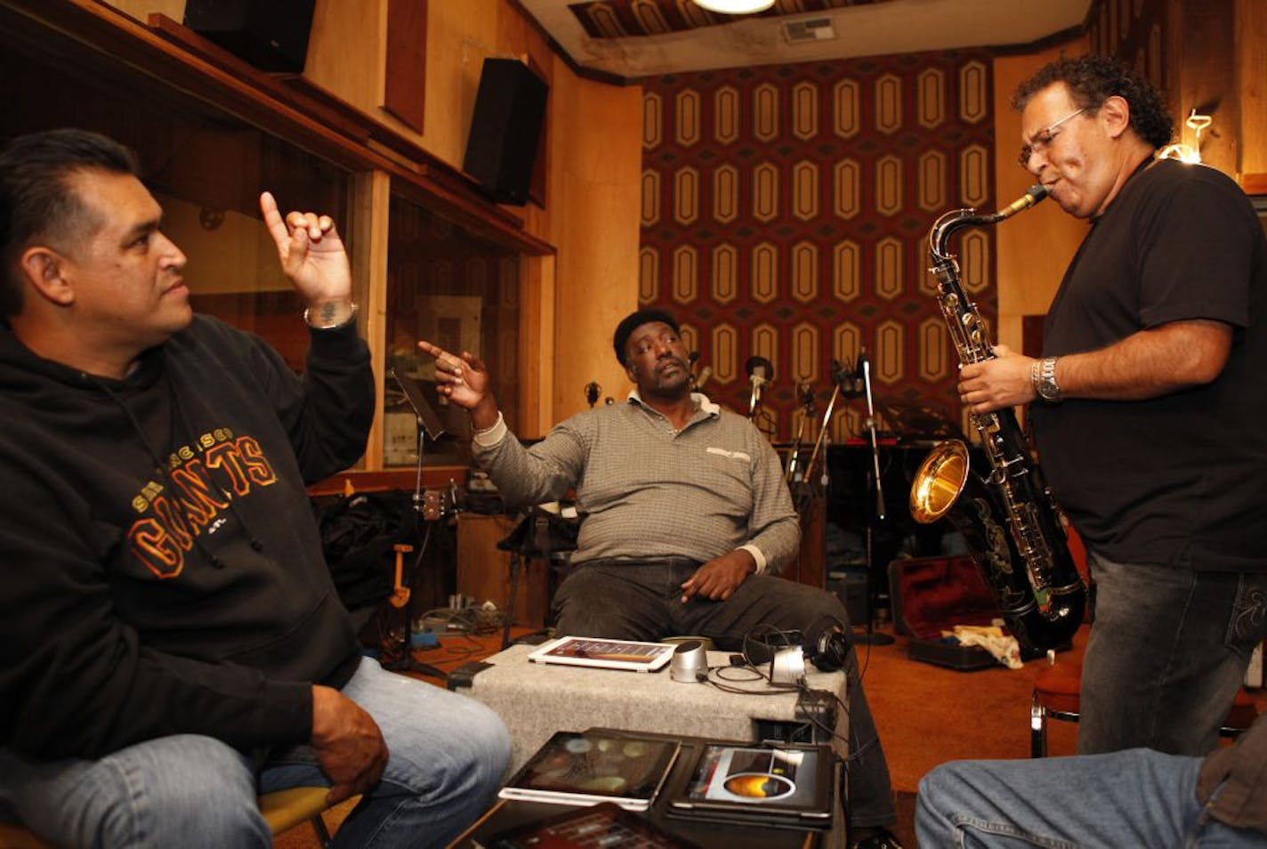 Drummer Donnie Green, left, guitarist J.C. Smith, center, and saxophone player Abraham Vasquez, right, lay down a track while testing out the new Jam Session feature of the GarageBand iPad app at Tiki Studios-O&apos;Neal Productions in San Jose, Calif., on Monday, June 4, 2012.