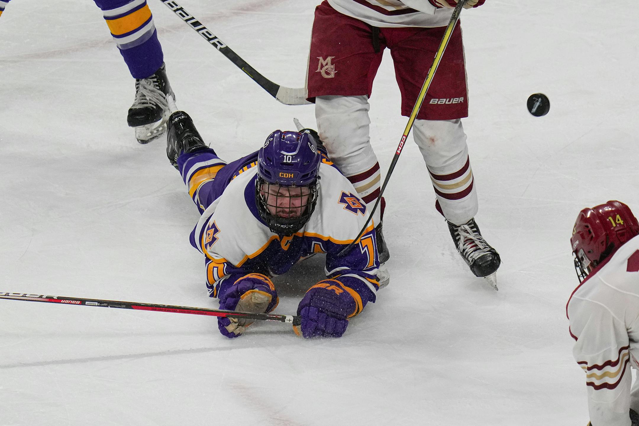 Cretin-Derham Hall defenseman Lucas Cernohous (10) dives after the puck in the second period.