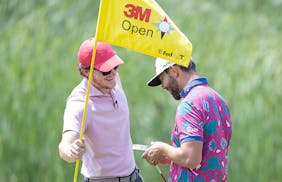 Alex Gaugert pulled the flag for his buddy Erik van Rooyen during a practice round Tuesday at the 3M Open at the TPC Twin Cities.