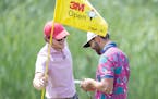Alex Gaugert pulled the flag for his buddy Erik van Rooyen during a practice round Tuesday at the 3M Open at the TPC Twin Cities.