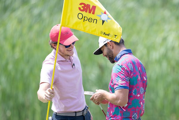 Alex Gaugert pulled the flag for his buddy Erik van Rooyen during a practice round Tuesday at the 3M Open at the TPC Twin Cities.