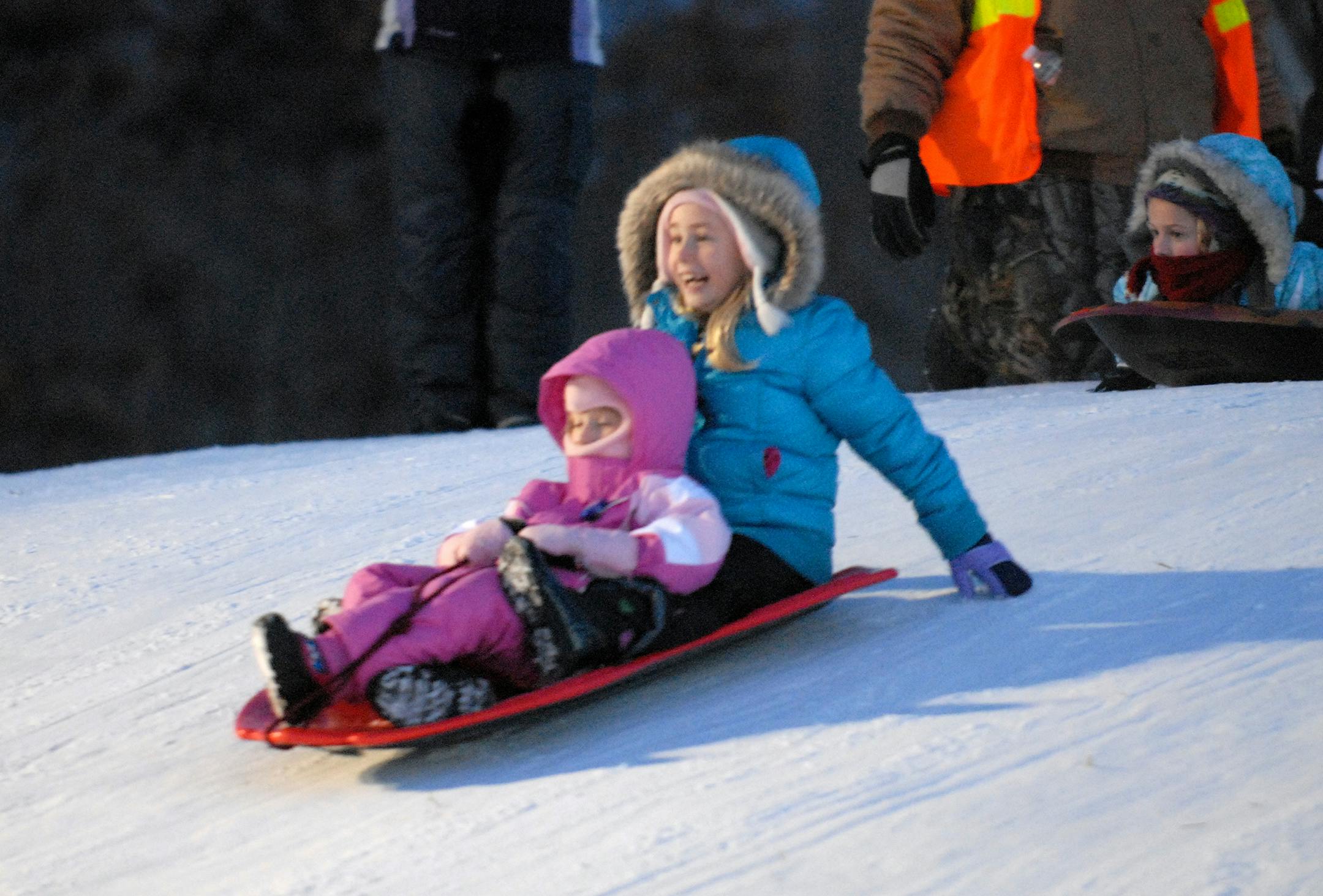 2013; Children; Female; Group; Lebanon Hills Regional Park; New Year's Eve Party; Night; Parks; Sledding; Snow; Winter. Photo by Dakota County Parks