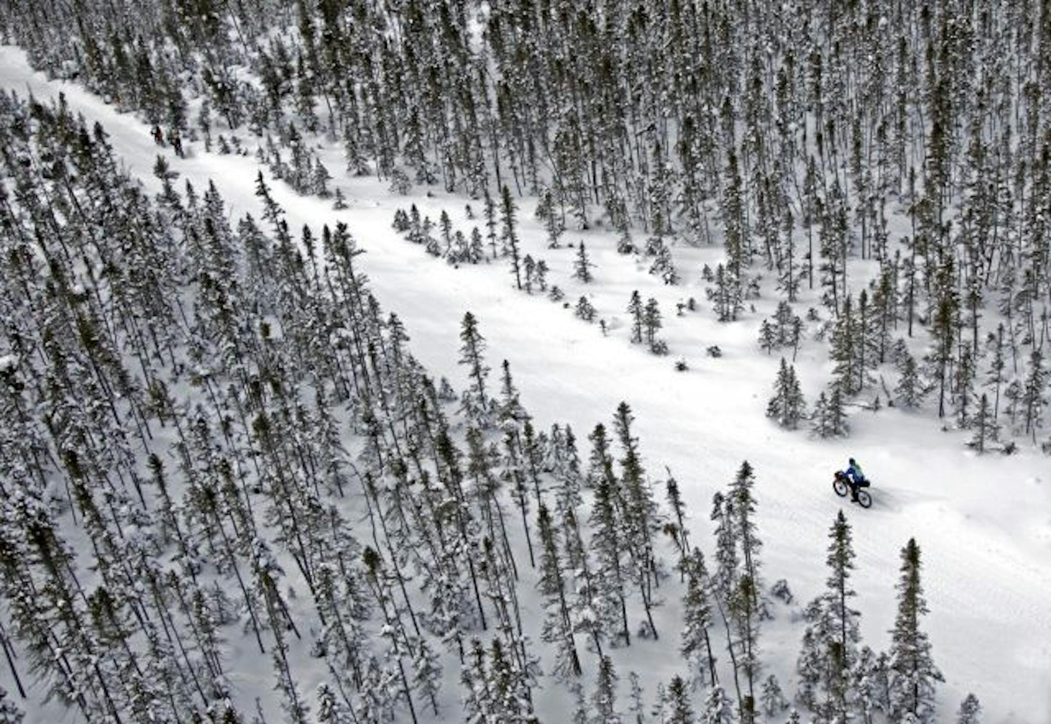 The Arrowhead 135 Ultra Marathon, from International Falls to Tower Minnesota, follows the scenic and rugged Arrowhead State Snowmobile Trail and attracts some of the best ultra-athletes in the world. Competitiers can Bike, run or ski the 135 mile race that challenges the body and the mind and presents participants with some of the coldest conditions in ultra marathon racing. (IN THIS PHOTO) Being alone and cold in the wilderness can play as much with your mind as the body. Racers are on their o